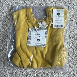 Kate Quinn long sleeve ruffle leg body suit